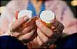 woman holding medication bottles